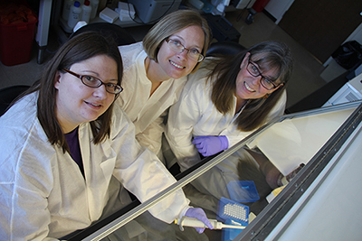 Kerri Basten (left), clinical lab analyst, with externs Heather Davidson and Lisa Skilang