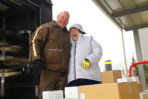 Deb Bryant, a clerk in her 43rd year with the Hygienic Laboratory, poses
with UPS driver Paul Yoerger after receiving a daily laboratory shipment.

