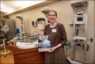 Emily Phillips holds the Newborn Screening manual in the University of Iowa Hospitals and Clinics Mother-Baby unit. Phillips co-authored the manual with Ashley Comer.