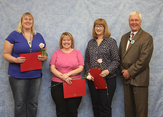 Five years of service (from left): Jennifer Elwood, Chris Anderson and Carol Adamson, with Director Atchison. Not shown are Beth Cawiezell, Dan Ellickson and Travis Henry.  